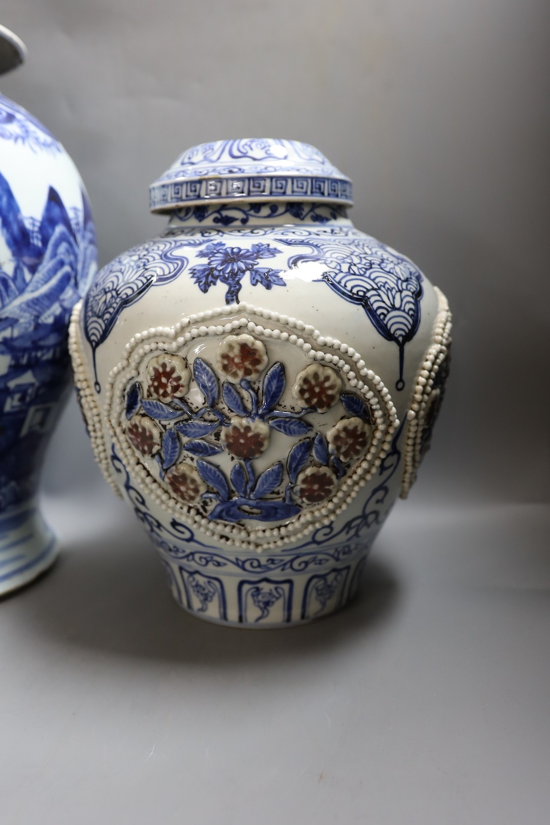 A large Chinese blue and white jar and cover and a blue and white jar and cover, 19th-century and later. Largest 44cm